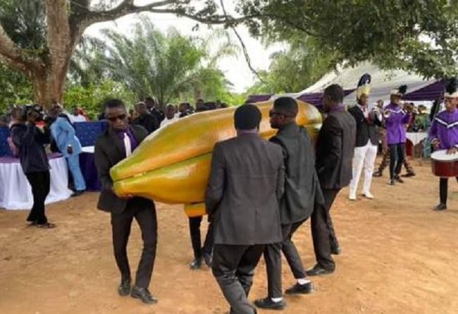 Lady Buries Father In A Gold Plated Pawpaw Shaped Coffin In Akwa Ibom